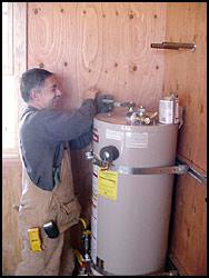  one of our pros is checking a water heater
